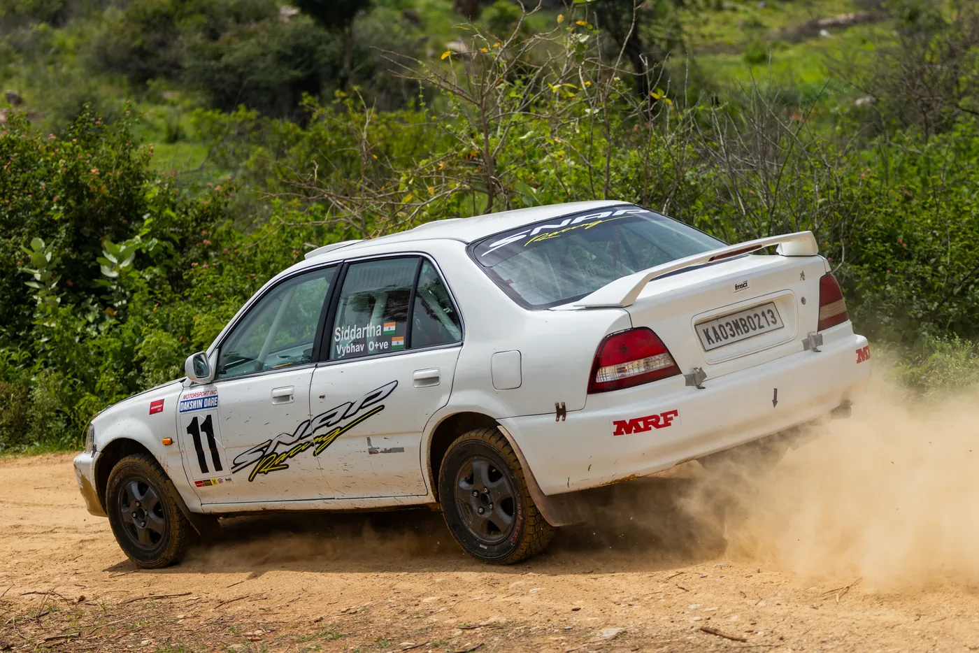 Rally car kicking up dust on a stage at Dakshin Dare