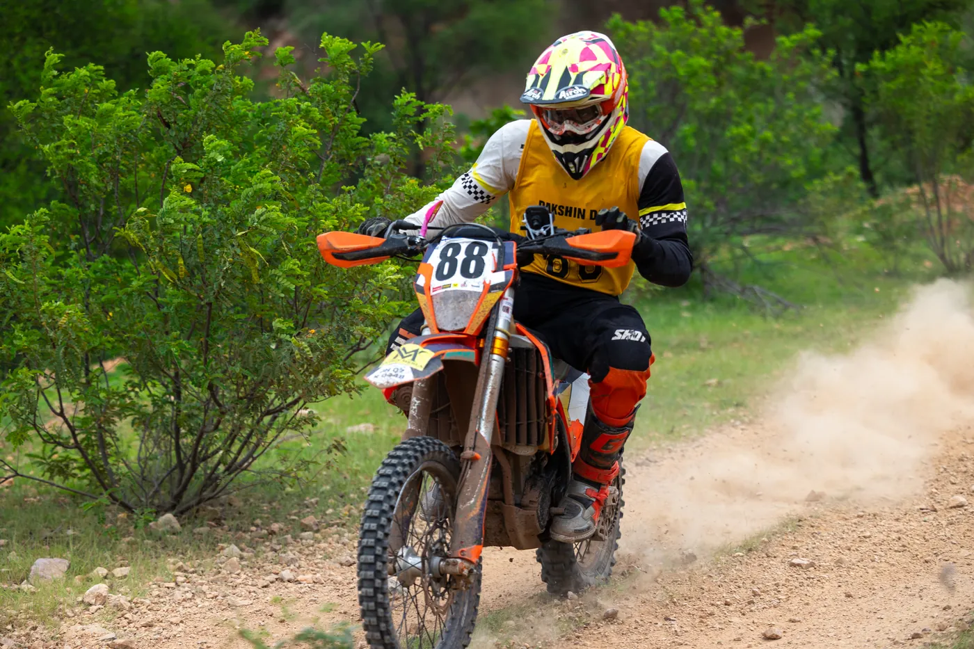 Motorcycle throwing up a dust roost at Dakshin Dare