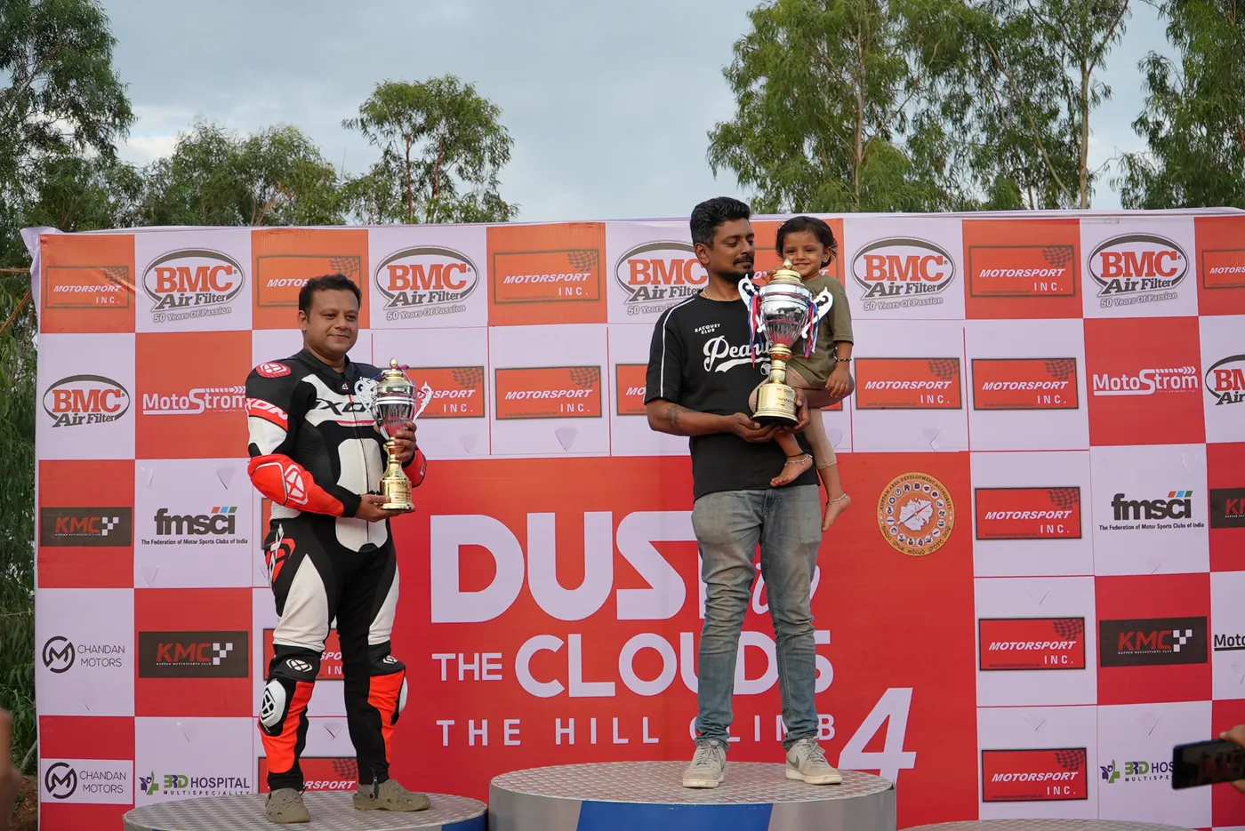 Rider celebrating with family on the Dust to the Clouds 4 podium