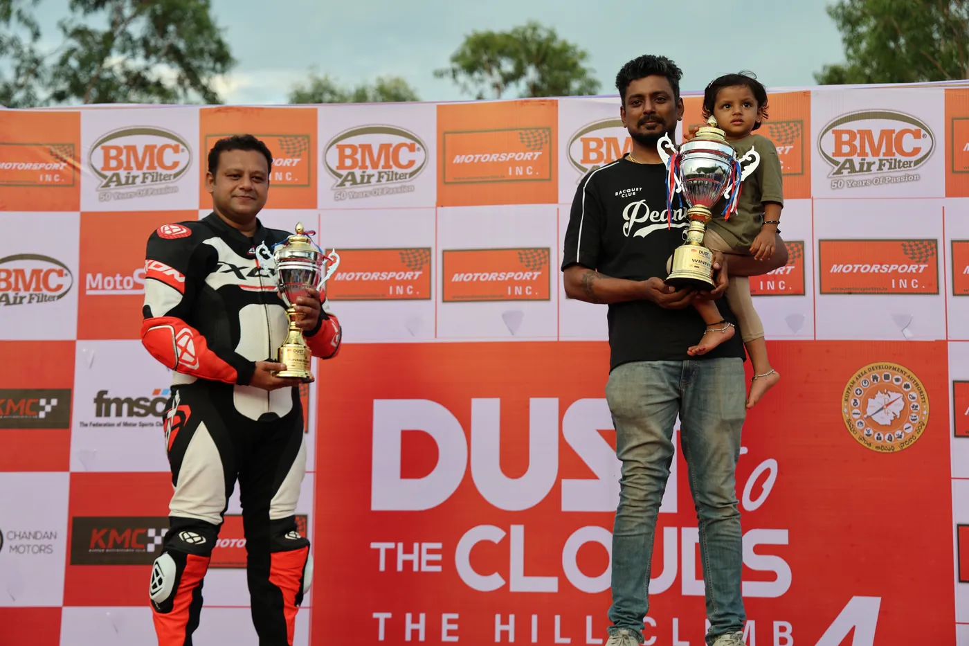 Class winner lifting the trophy with his kid at Dust to the Clouds 4