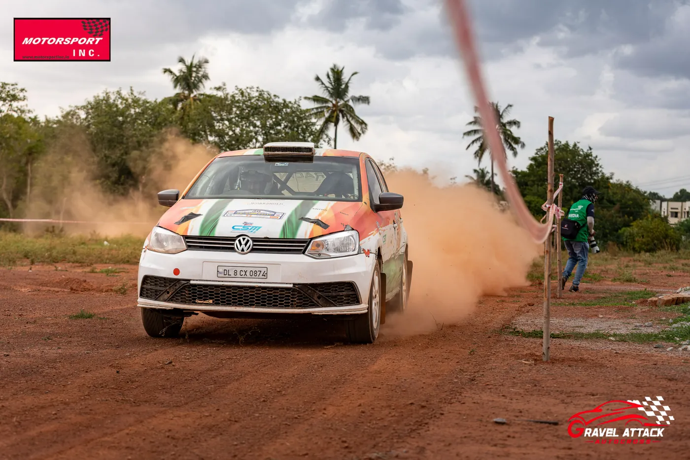 Car powering around a marker flag in a cloud of dust at Gravel Attack