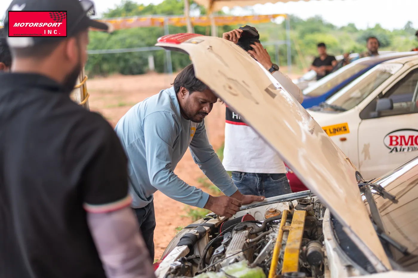 Marshals scrutineering a rally car before the start