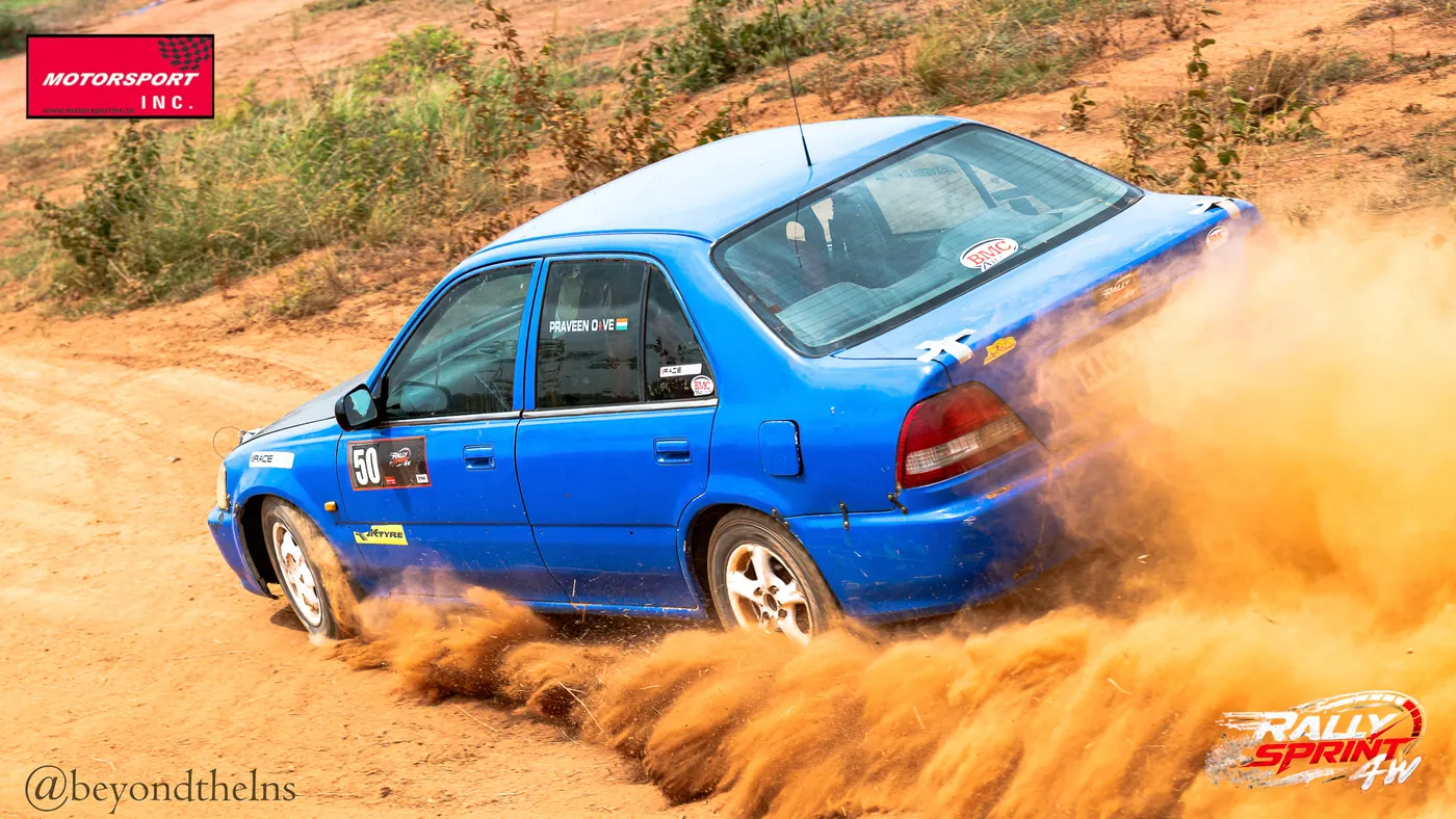 Sedan sliding through a dusty corner at Rally Sprint 4W