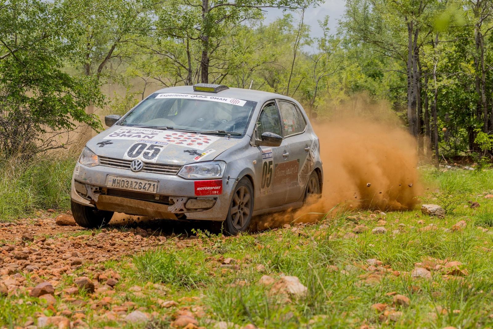 Rally car throwing dust on a gravel stage